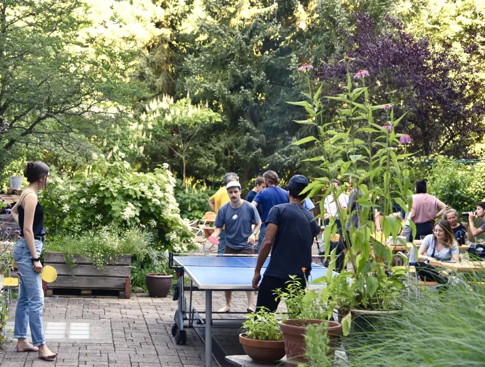 photo of people playing ping-pong in the outdoor-area of hostel77